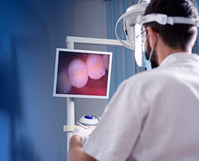 Dentist looking at picture of teeth taken with intraoral camera