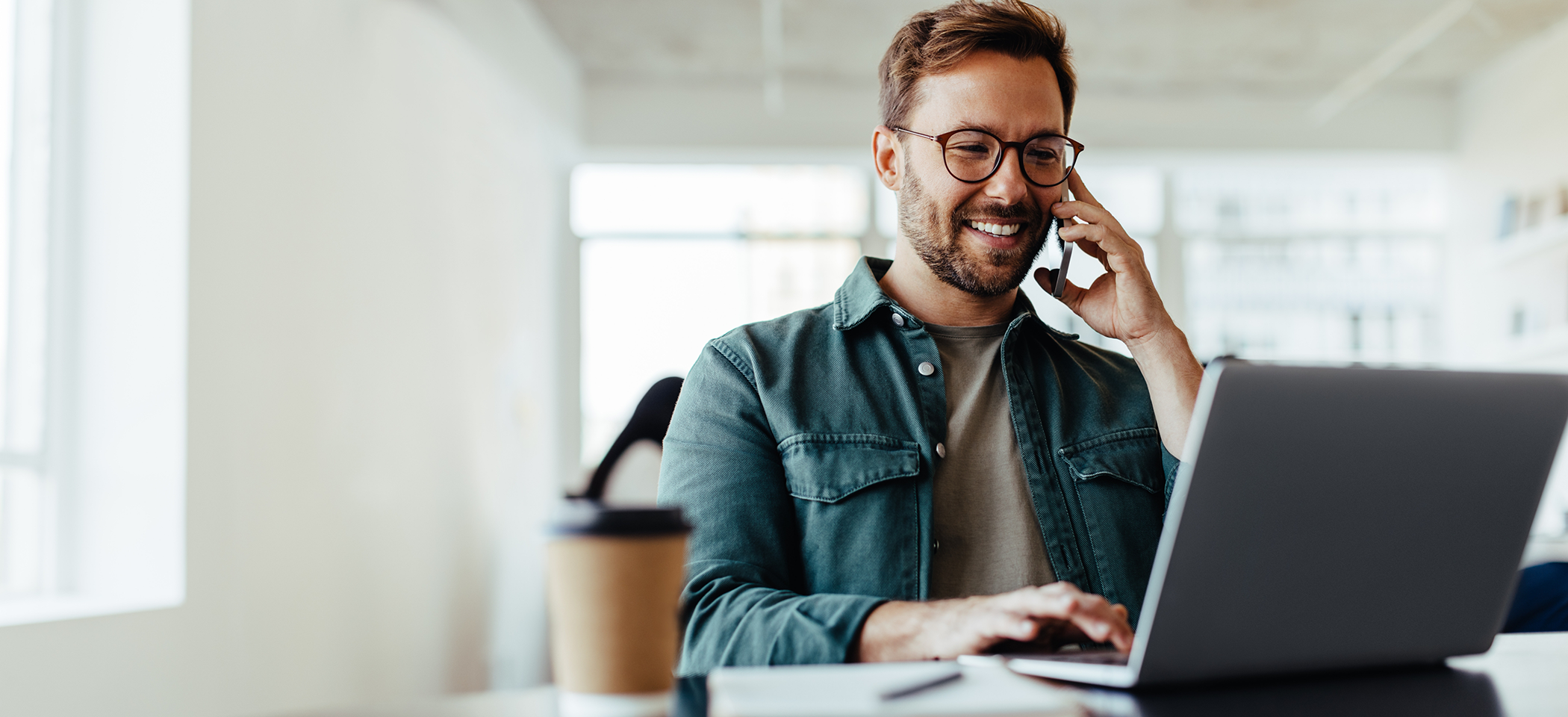 Man with glasses talking on phone