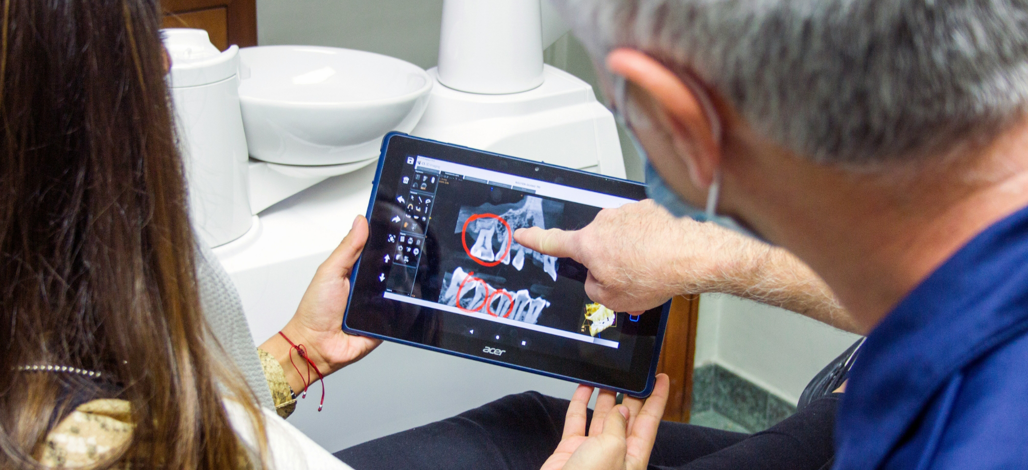 Dentist in Midlothian pointing to tooth circled on dental X-ray