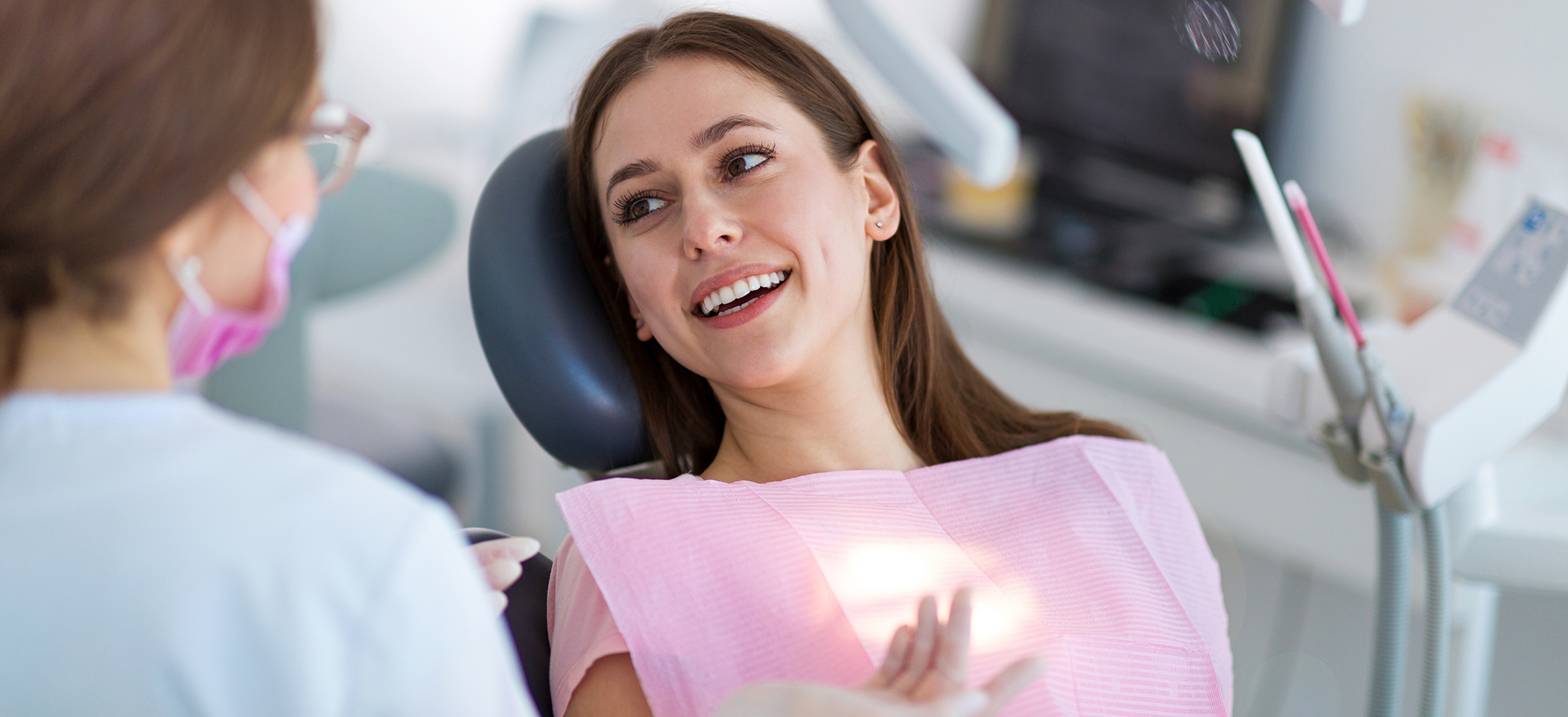 Female dental patient smiling at dentist